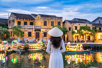 Asian woman wearing vietnam culture traditional at Hoi An ancient town, Vietnam. Hoi An is one of...