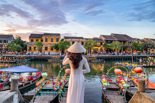 Asian woman wearing vietnam culture traditional at Hoi An ancient town, Vietnam. Hoi An is one of the most popular destinations in Vietnam  from Korea, Thailand, USA, Japan, China