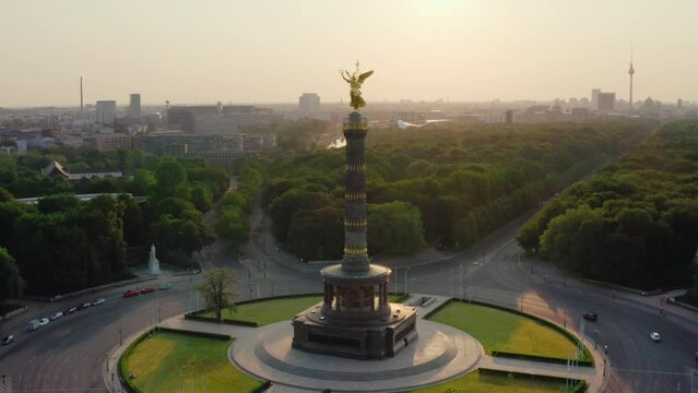 Establishing Aerial view of Berlin Cityscape with Victory Column. Major tourist attraction and viewing platform. Tiergarten park and other German Landmarks. 4K drone orbit shot on golden sunrise