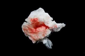 white tissue with blood clots with dark background. white tissue used to wipe blood from wounds