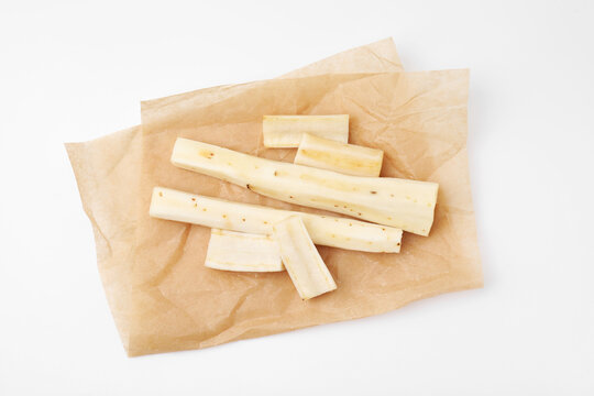 Cut raw salsify roots on white background, top view