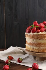 Tasty cake with fresh strawberries and mint on wooden table, closeup. Space for text