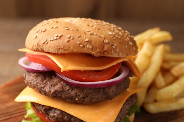 Delicious burger with meat cutlets, cheese and vegetables on wooden table, closeup