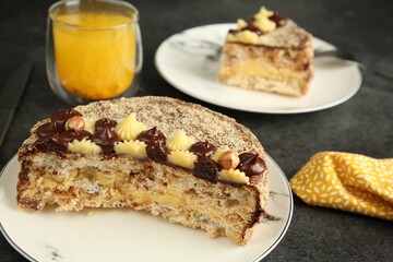 Delicious Kyiv Cake served with drink on black table, closeup