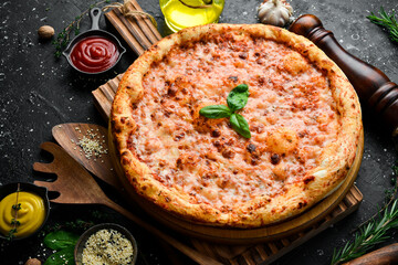 Pizza margherita. classic pizza On a black stone background. Top view.