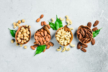 a set of nuts in a bowl on a light stone background. Healthy snacks. Nuts