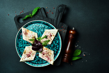 Traditional Azeybarzhan Burum: pita bread and greens. Free space for text. On a dark background.
