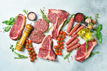 Meat background. Steaks, kebabs, cutlets and veal. Meat products. On a gray stone background. Top...