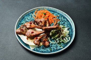 Grilled lamb steak on the bone with onions and pita bread. Barbecue menu. Free space for text. Close up.