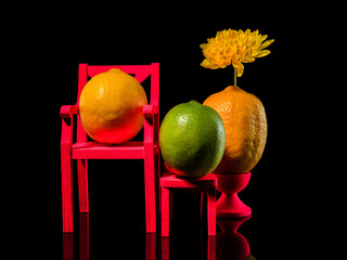 Composition with two lemons and lime on a black background