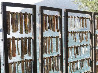 Symbolic display of traditional sardine drying on the lakeside of Montisola, Italy - 675721755