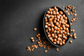 Nuts background. Hazelnuts in a black oval bowl. Healthy Eating. Close up.