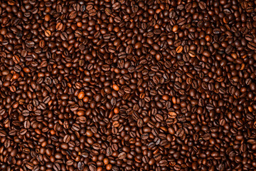 roasted coffee bean background, top view. Macro photo. Free space for text.