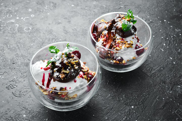 Ice cream with chocolate, cherry toppings, in a glass creamer. Restaurant menu. Rustic style.