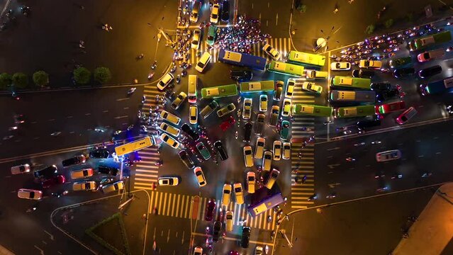 Aerial time-lapse of evening traffic at intersection in Ho Chi Minh City, Vietnam.