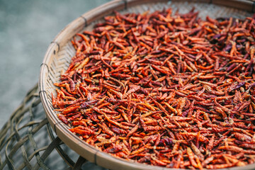 Fototapeta premium Dried red chilies in a wooden basket to be used as a seasoning in food.