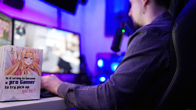Manga comic cover with cute anime girl on table while man gaming in background
