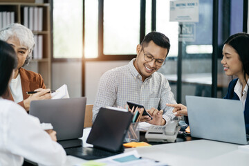 Business team working on a project in the office or reviewing and discussing a business project.