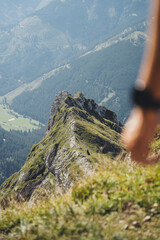 Mountain summit with hand in the foreground