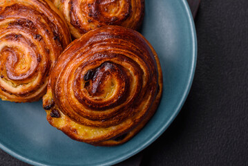 Delicious baked cinnamon raisin rolls in the form of rolls