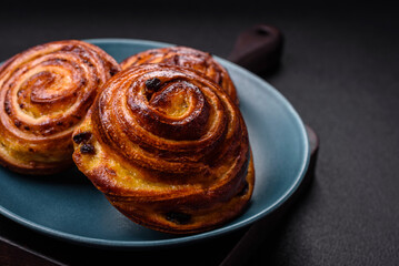 Delicious baked cinnamon raisin rolls in the form of rolls