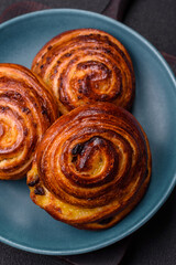 Delicious baked cinnamon raisin rolls in the form of rolls