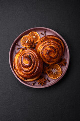 Fototapeta premium Delicious baked cinnamon raisin rolls in the form of rolls