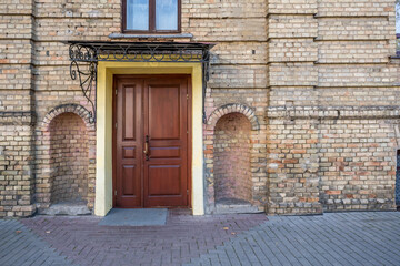 wooden doors to an old brick building