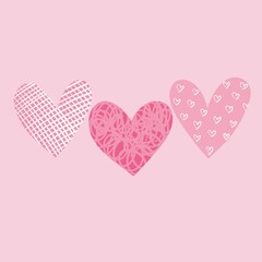 three hearts with different patterns on a light pink background