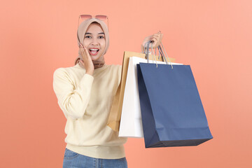 sunglasses holding package bag with purchases after shopping