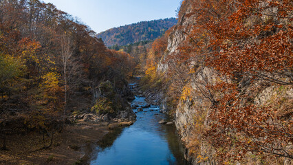 Fototapeta na wymiar An autumn mountainous vista with romantic riverscapes.