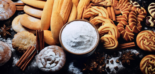 Fototapeta premium still life of cookies with chocolate on a wooden table, dark background, delicious pastries