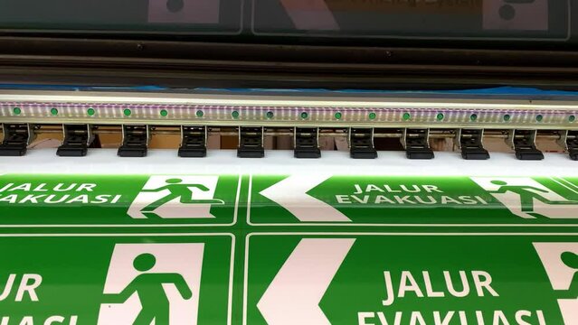 Close up of an industrial sticker printer at work.