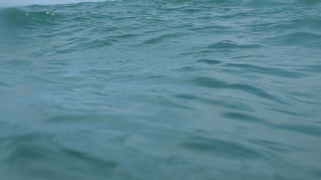 Ocean surface shot: camera's plunge and ascent emulate a cry for rescue.