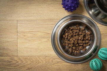 Pet food concept - dry pet food on bowl on wood background