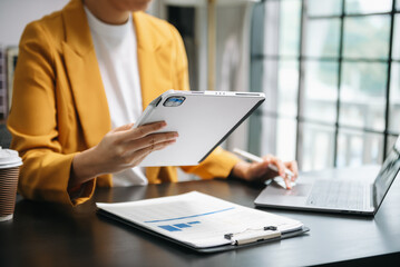 businessman working with digital tablet computer and smart phone with financial business strategy layer effect on desk