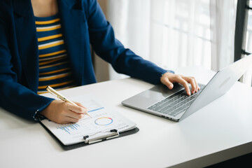 businessman working with digital tablet computer and smart phone with financial business strategy layer effect on desk