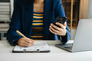 businessman working with digital tablet computer and smart phone with financial business strategy layer effect on desk