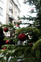 Fototapeta na wymiar Beautiful red Christmas balls and green fir branches. Festive background.