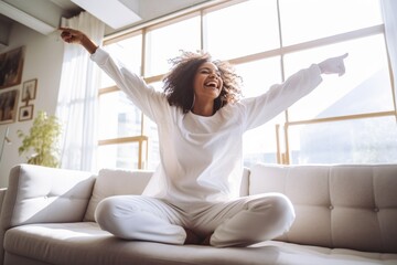Happy afro american woman relaxing on the sofa at home. Smiling girl enjoying day off lying on the couch. Healthy life style, good vibes people and new home concept. - obrazy, fototapety, plakaty