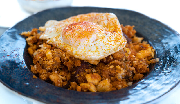 Typical Spanish dish called "migas extreme&ntilde;as", made with crumbs, meat, paprika, egg, oil and garlic