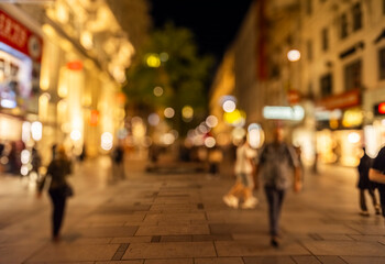 Crowd of anonymous people walking on busy city street at night , urban city life background - obrazy, fototapety, plakaty