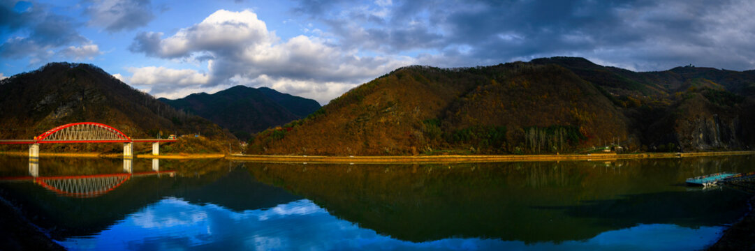 Danyang South Korea autumn landscape at Subyon Water Park with Gosu Daegyo Bridge over Chungju Lake in Chungcheongbuk-do, Korea, with distant view of Sobaeksan Mountains National Park