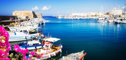 Heraklion old venetian harbour with colorful small fishing boats, yachts and ships, Heraclion...