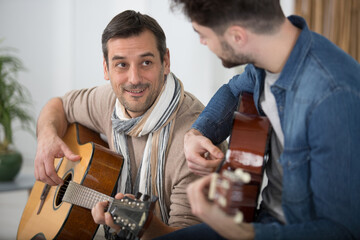 two guitar players with classic guitars space for text