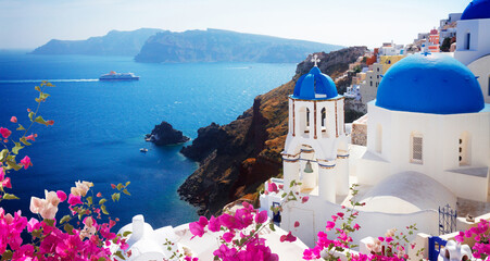 volcano caldera with blue church domes, Oia with flowers, Santorini, toned