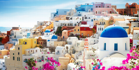 cityscape of Oia, traditional greek village of Santorini with flowers, Greece