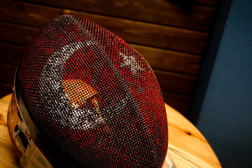 Fencers mask painted in Turkish flag colors close up view