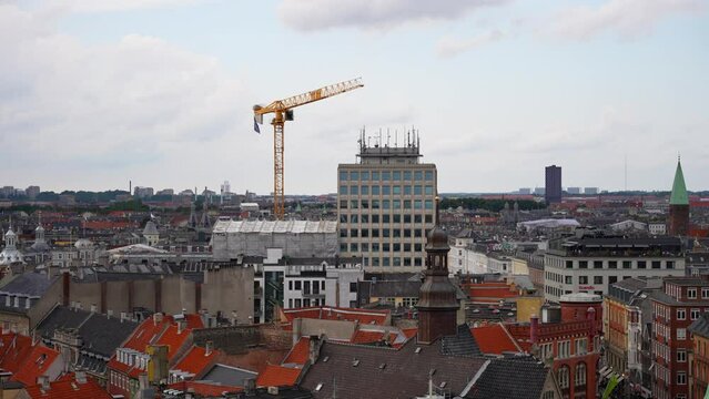 Tower crane at building construction site seen from The Round Tower in Copenhagen, Denmark. Wide