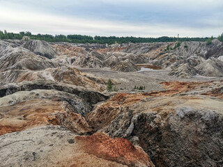 Obraz premium Ural Mars. An extraordinarily beautiful summer landscape with red lakes, colorful slopes and forest. A picturesque mountain range. Natural landscape, impressive sky. Nature of the Urals. 4K